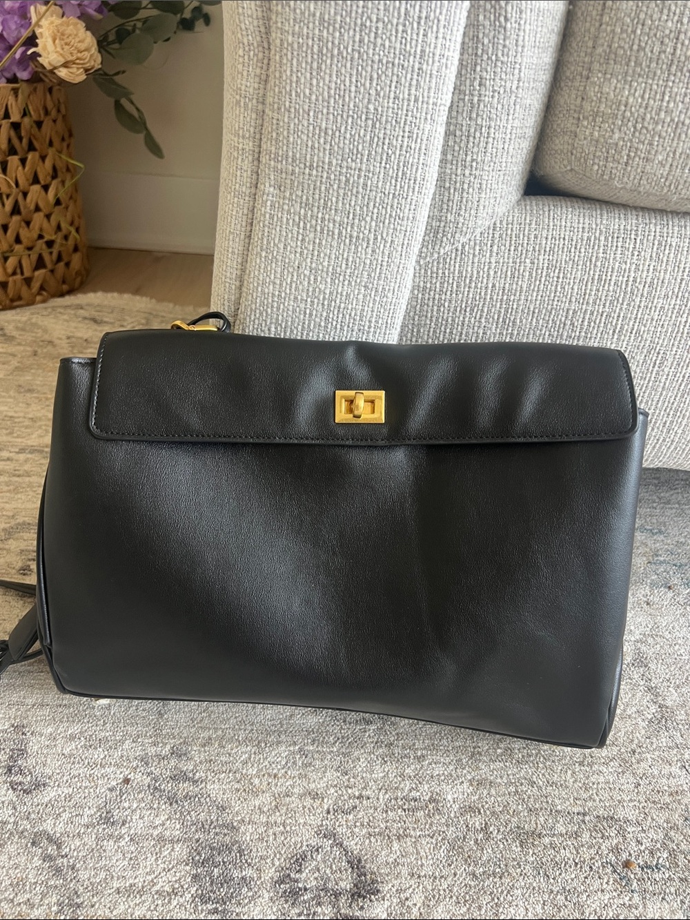 Black handbag can be shoulder or cross body bag .